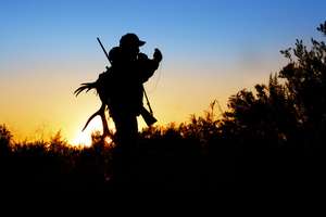 Silhouette of hunter with gear, know hunting laws by state concept.