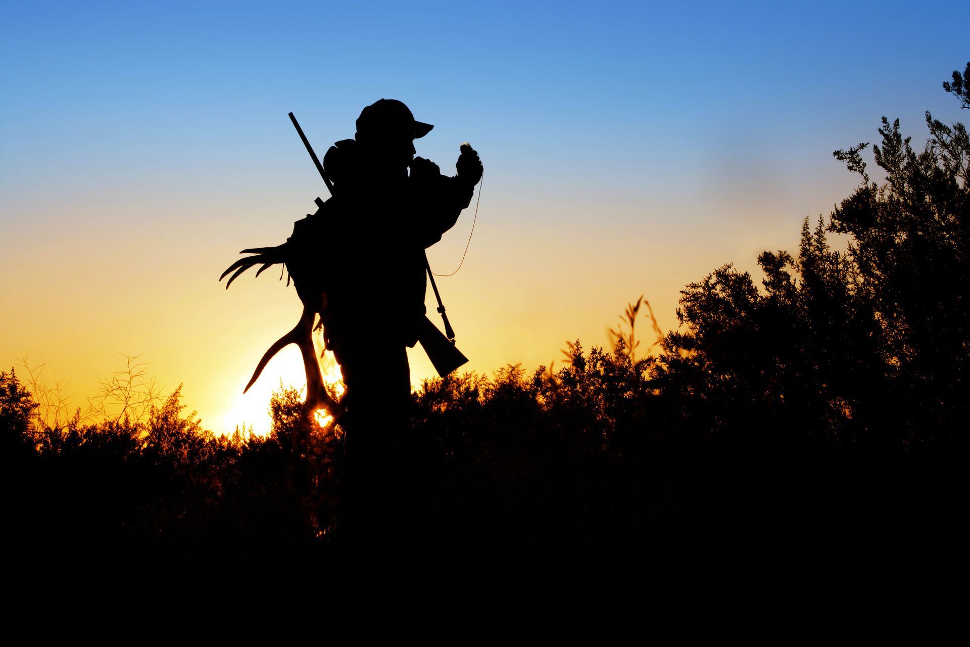 Silhouette of hunter with gear, know hunting laws by state concept. 