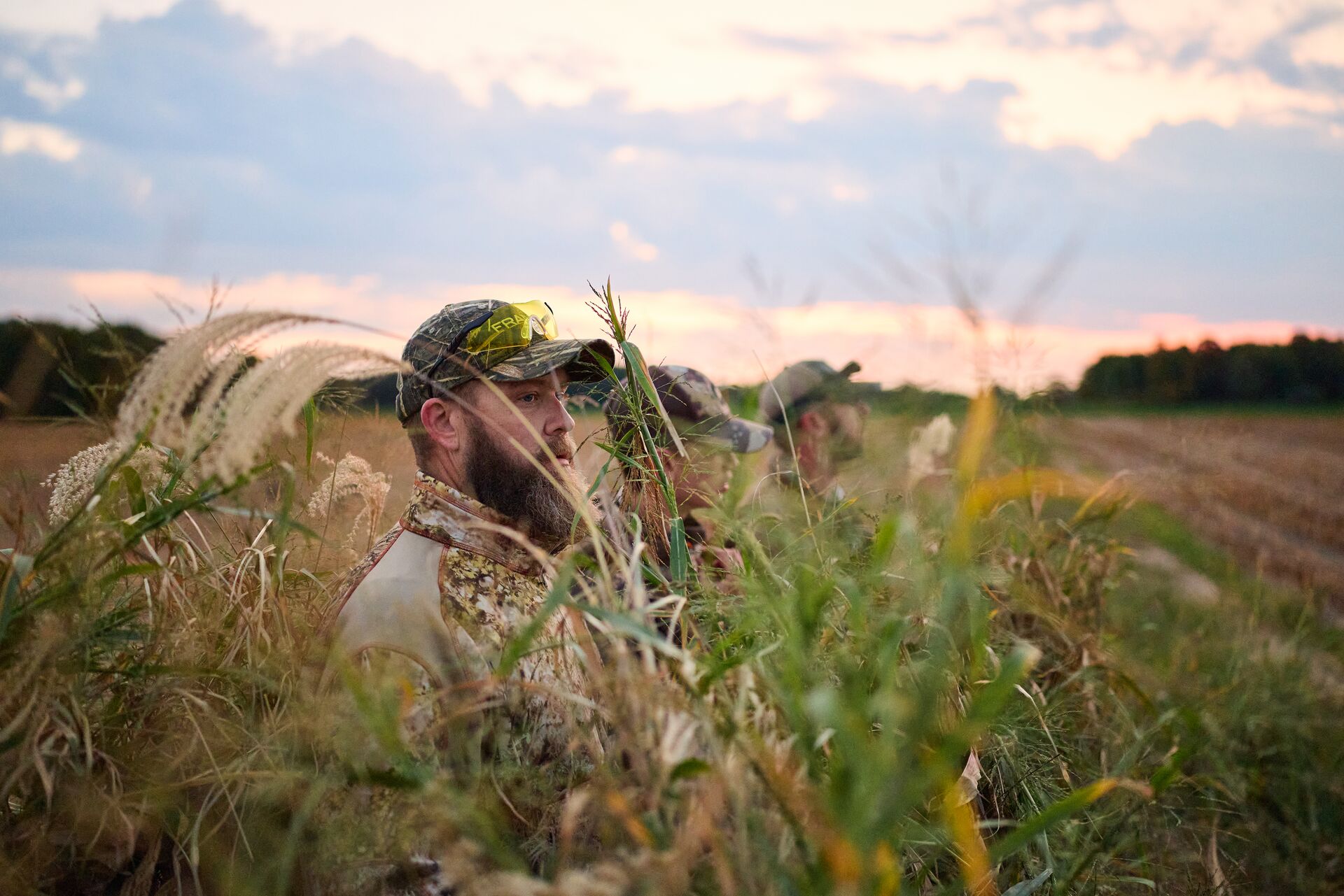 Several hunters at edge of field, apprentice hunting license in Michigan concept. 