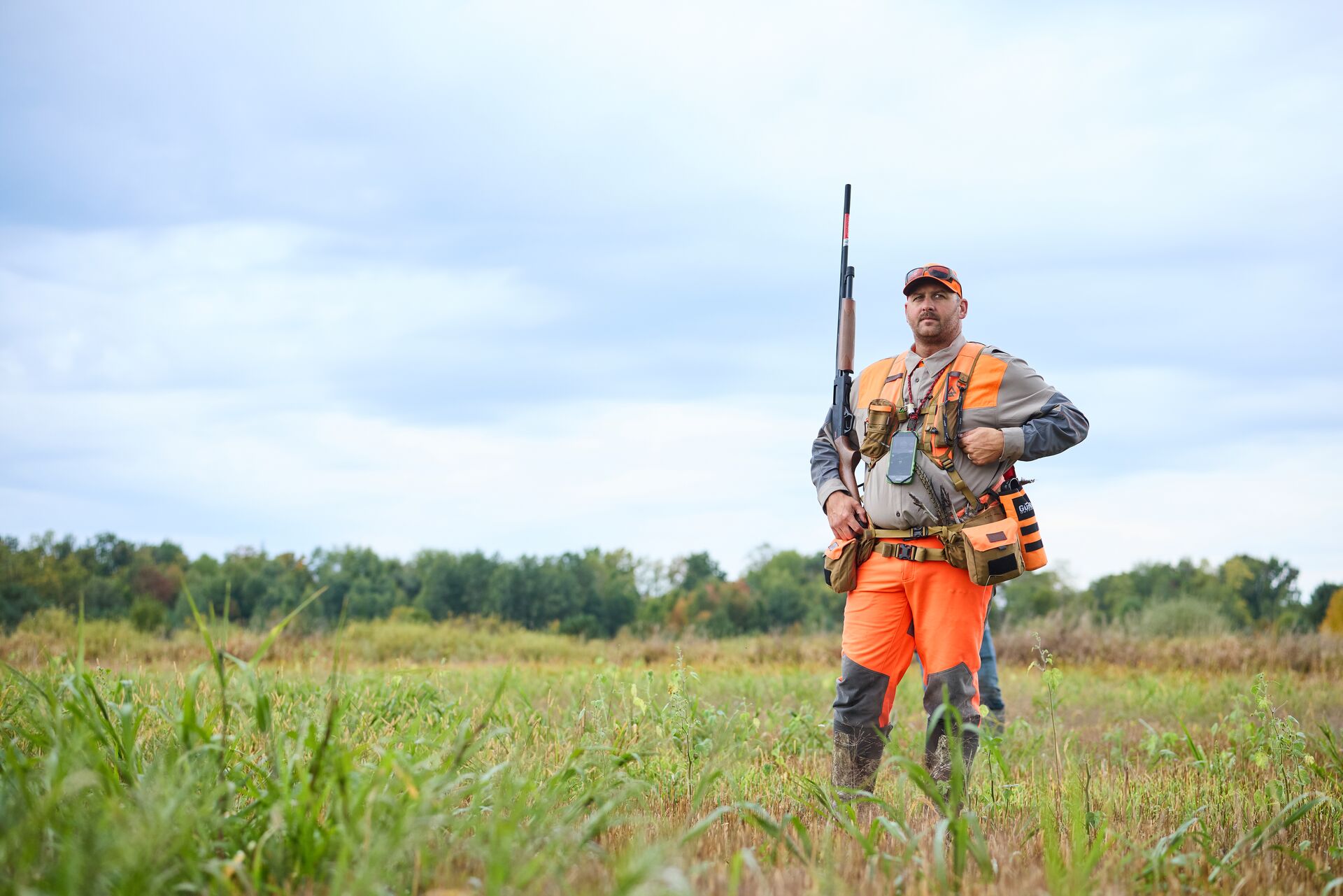 Hunter in blaze orange for upland bird hunt. 