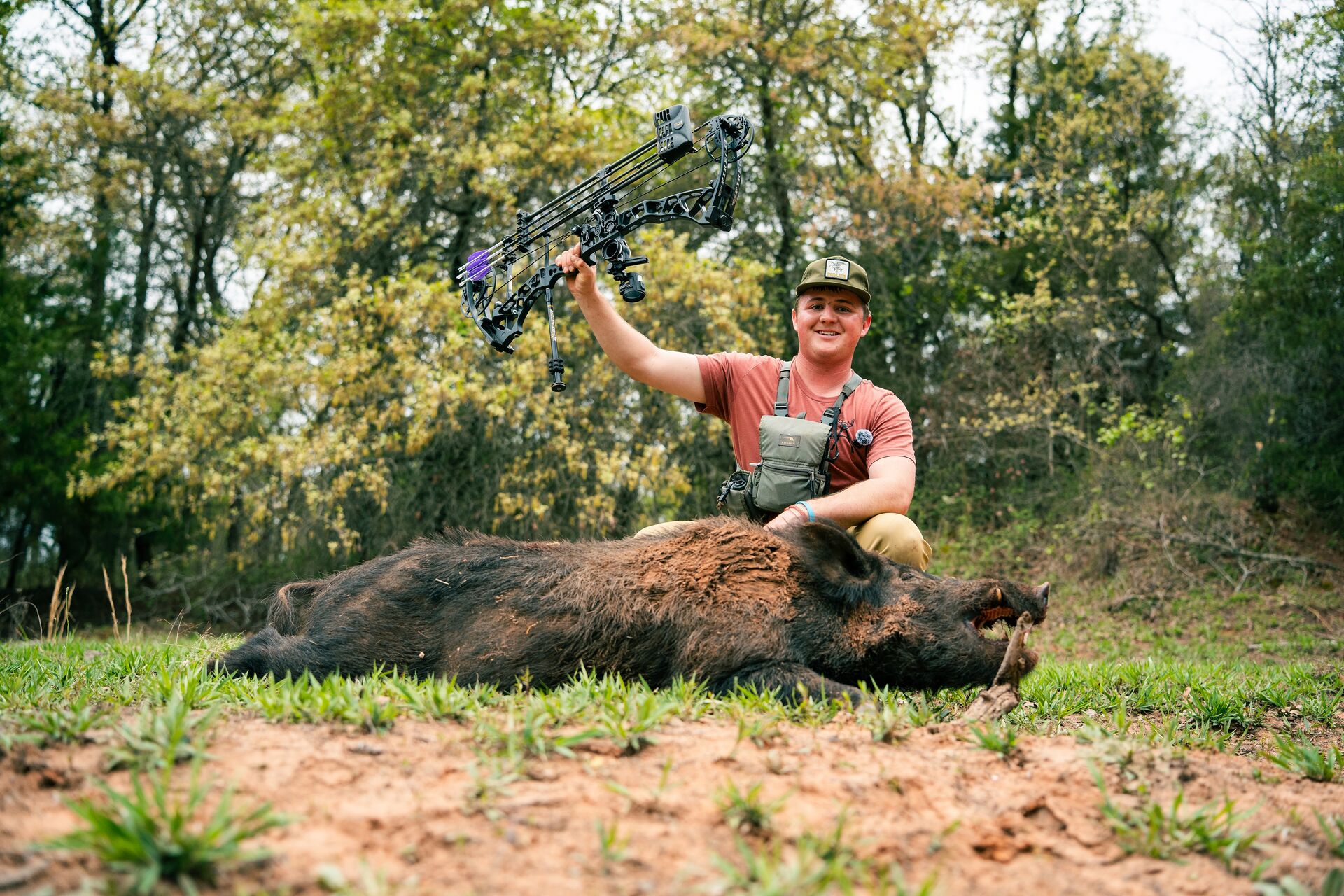 Hunter with wild boar and bow after hunt, requirements for a hunting license in texas concept. 