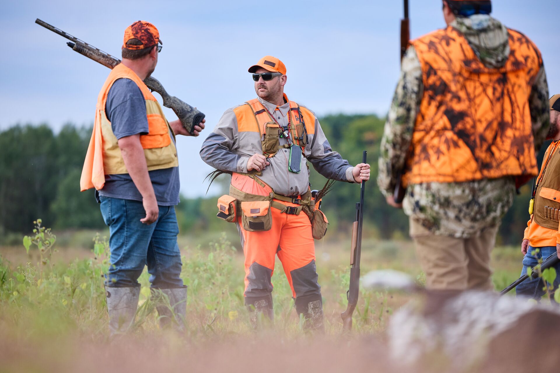 Group of hunters in blaze orange for upland hunt. 