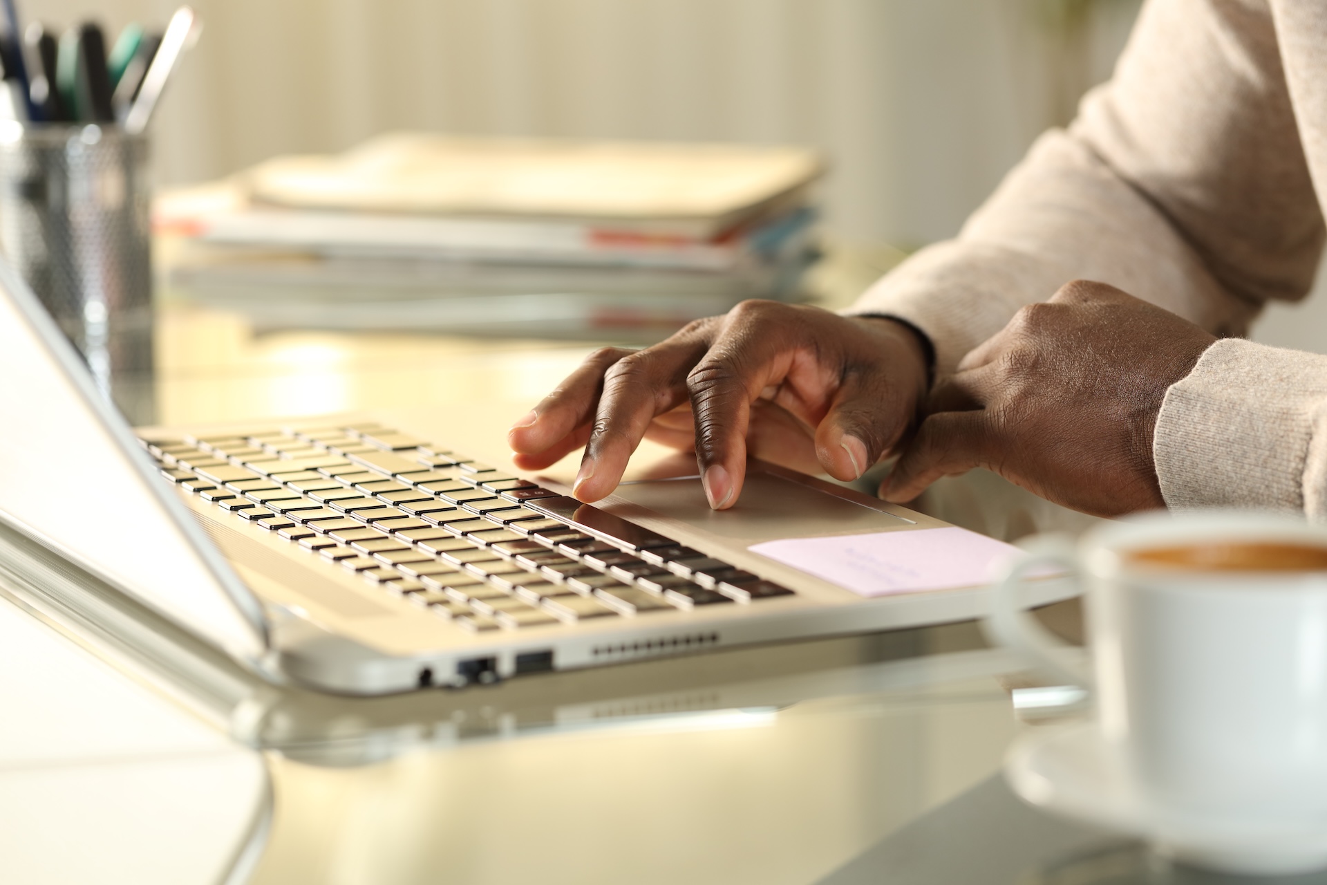 Close-up of hands using a laptop keyboard, take an online hunter safety course concept. 