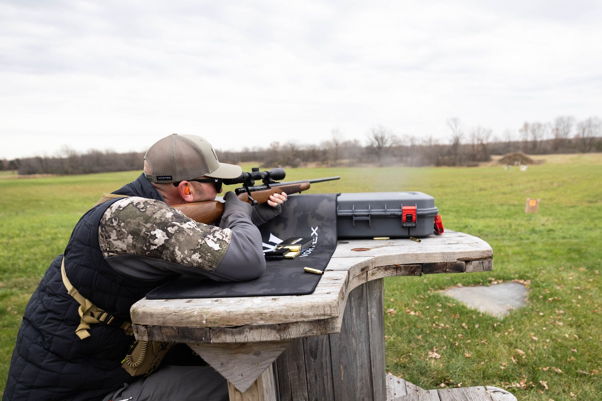 Hunter aims rifle at the range, hunter safety certification concept.
