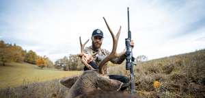 Hunter on the ground looks at buck deer, how to start hunting as an adult concept.