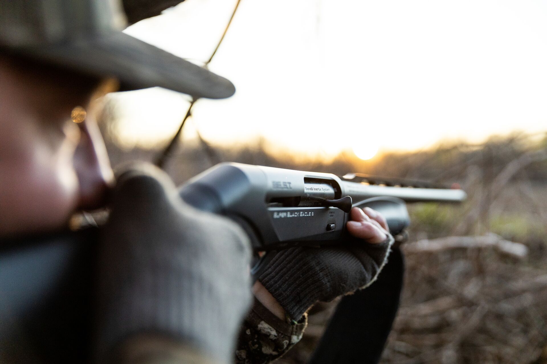 A hunter aims a shotgun, using sights on shotgun firearms concept. 