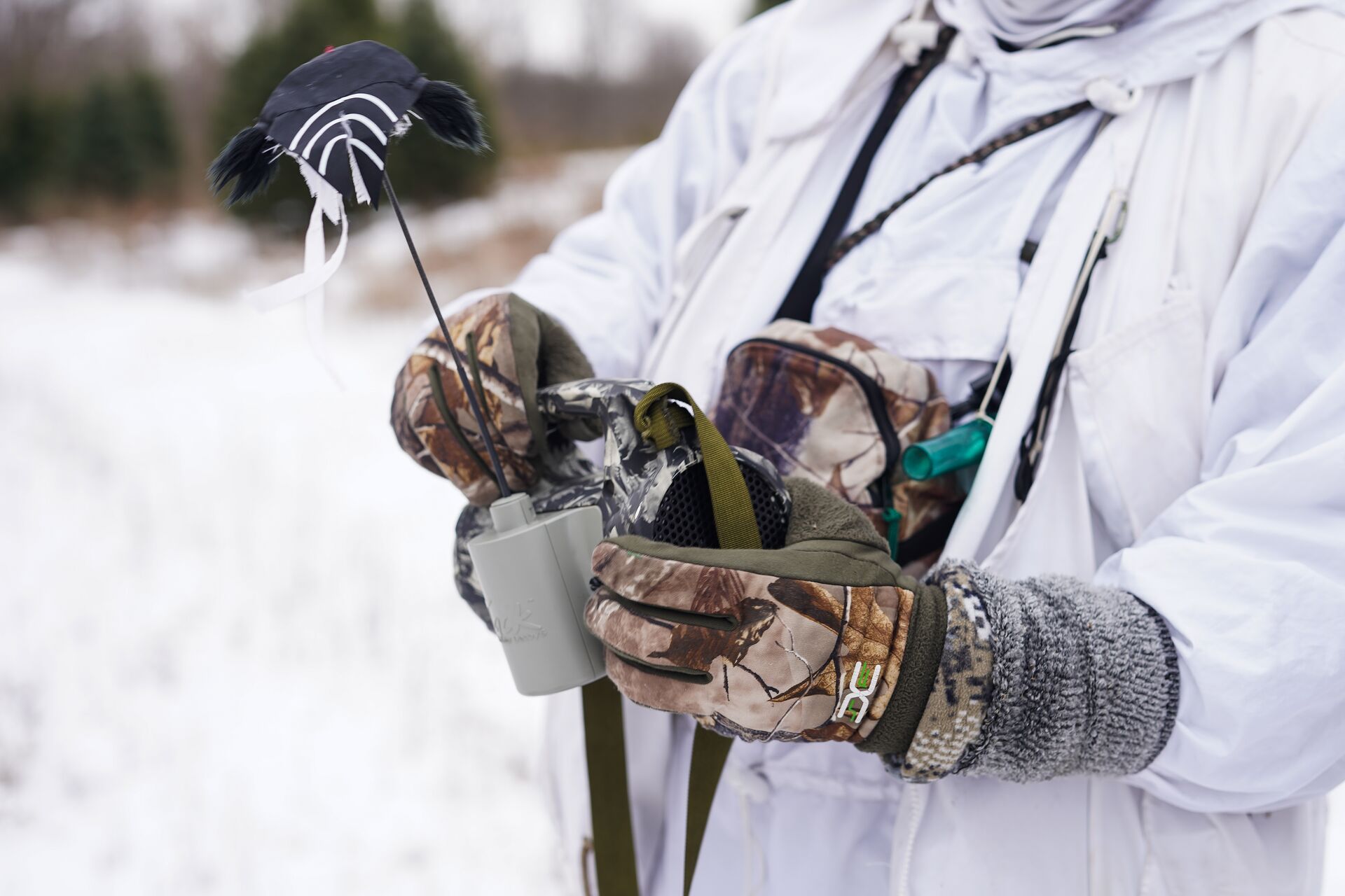 A hunter holds a coyote decoy.