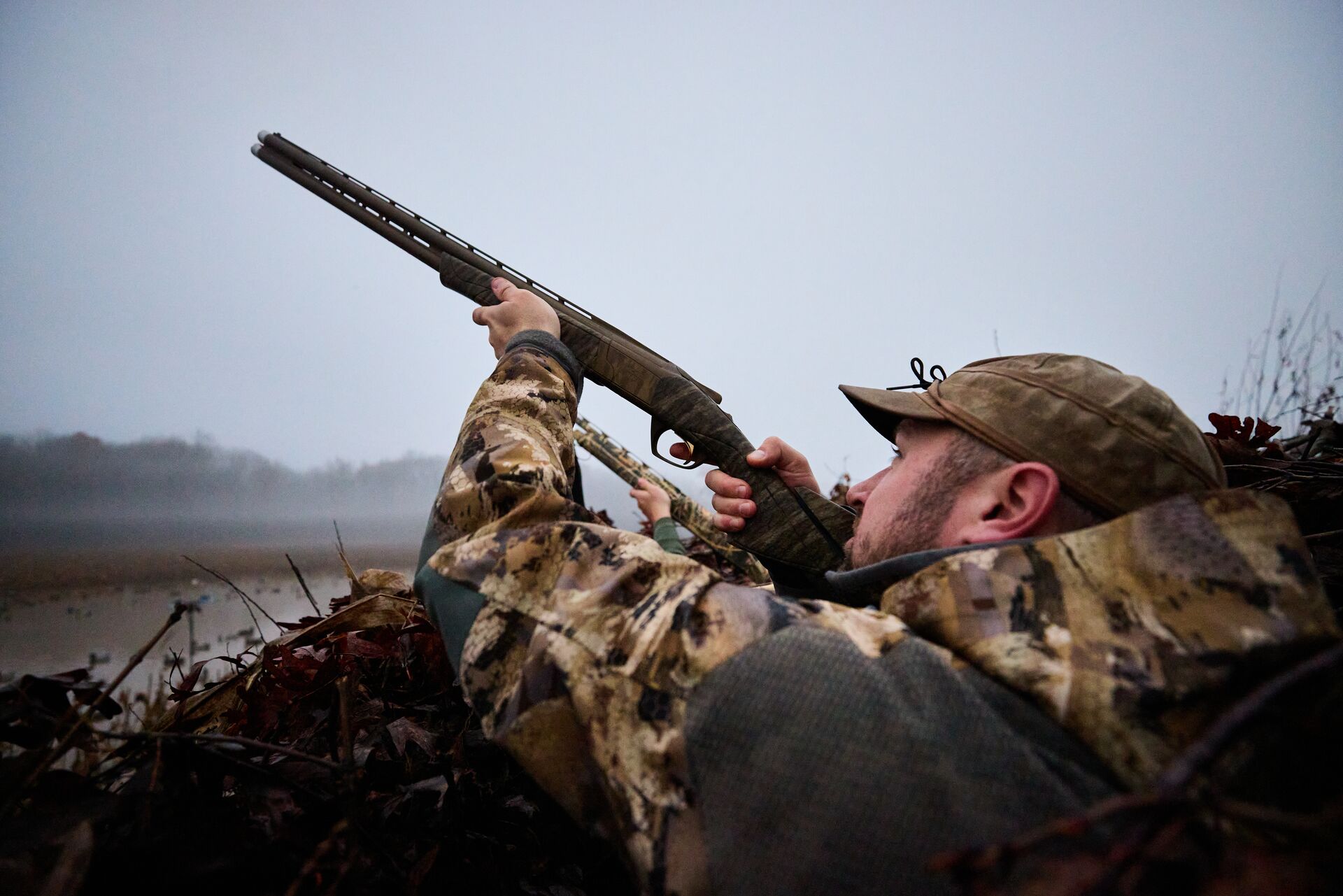 Hunter aims a shotgun in the air, what is a safe zone of fire concept.