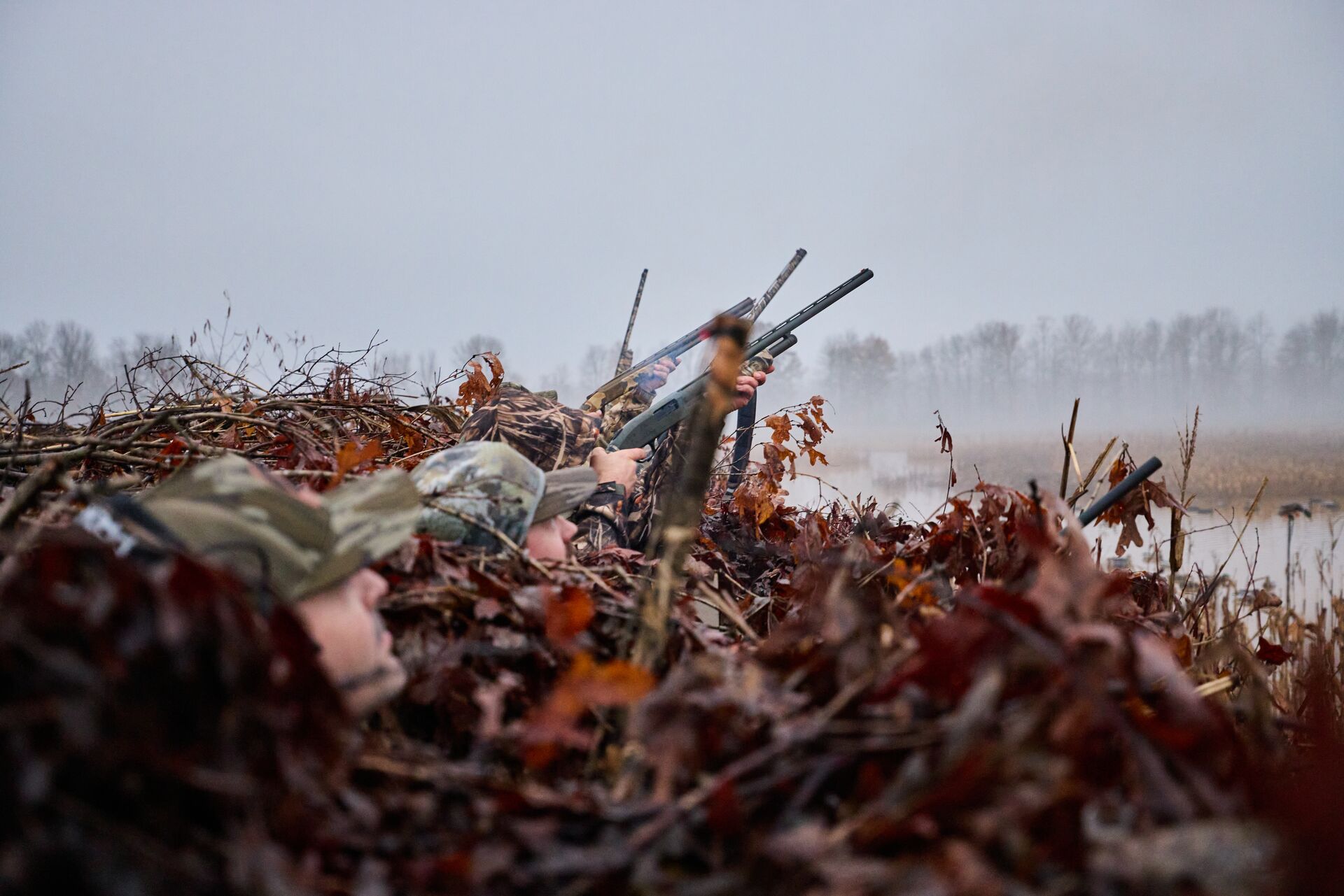 Hunters in a duck blind aiming shotguns, what is a safe zone of fire concept. 