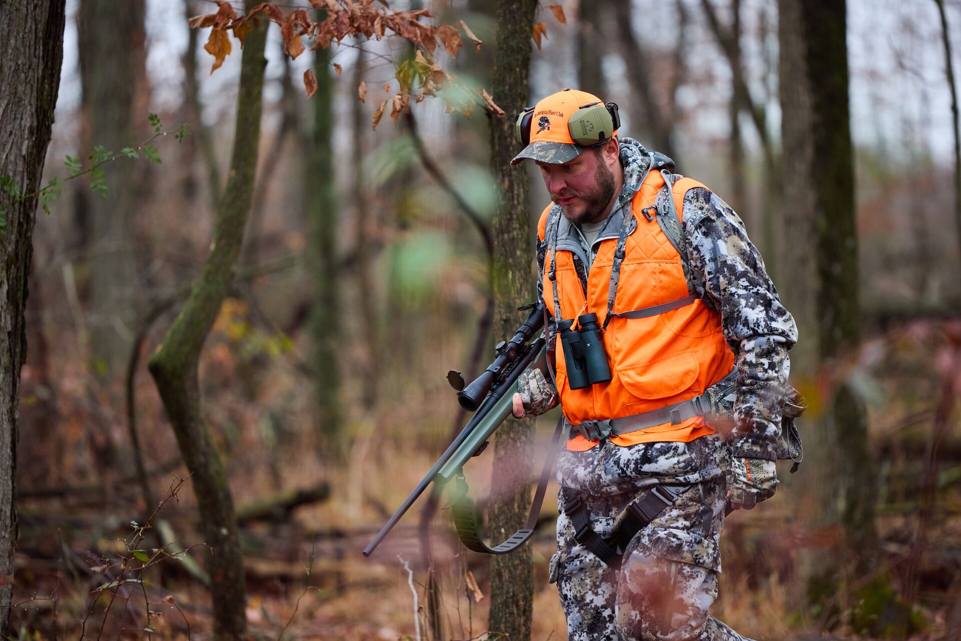 A hunter wears blaze orange and carries a rifle, why do hunters wear orange concept.