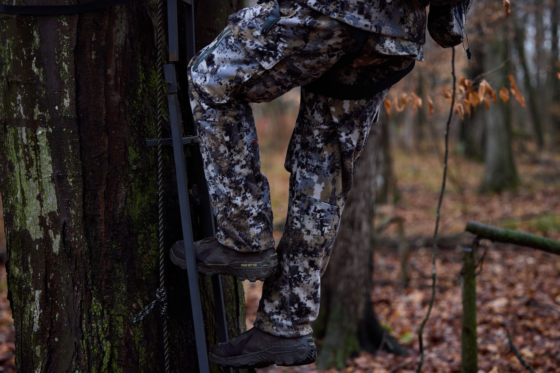 Close-up of hunter's legs climbing into tree stand, tree stand safety concept.