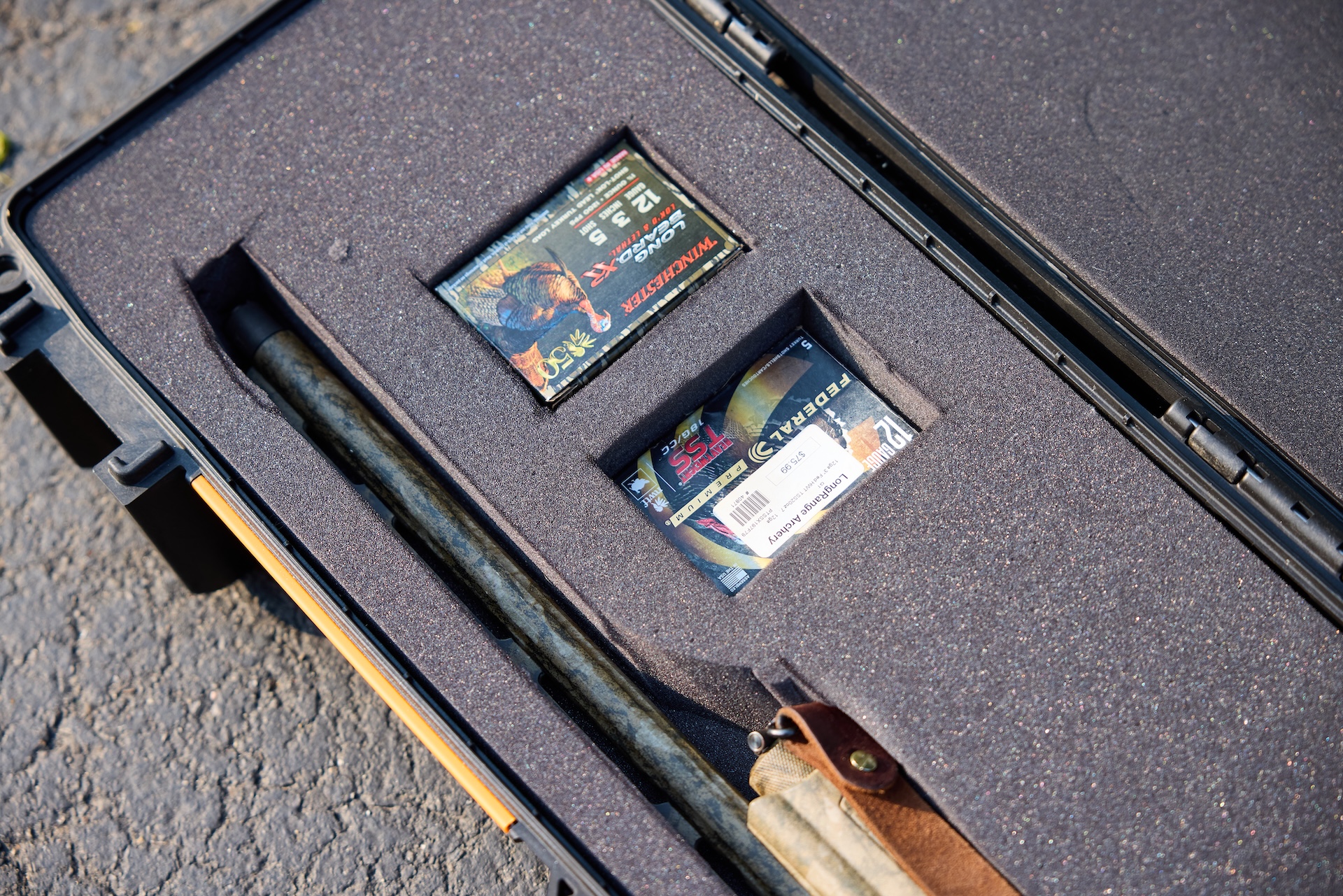 Ammunition boxes next to rifle in hard case, flying with hunting rifle concept.