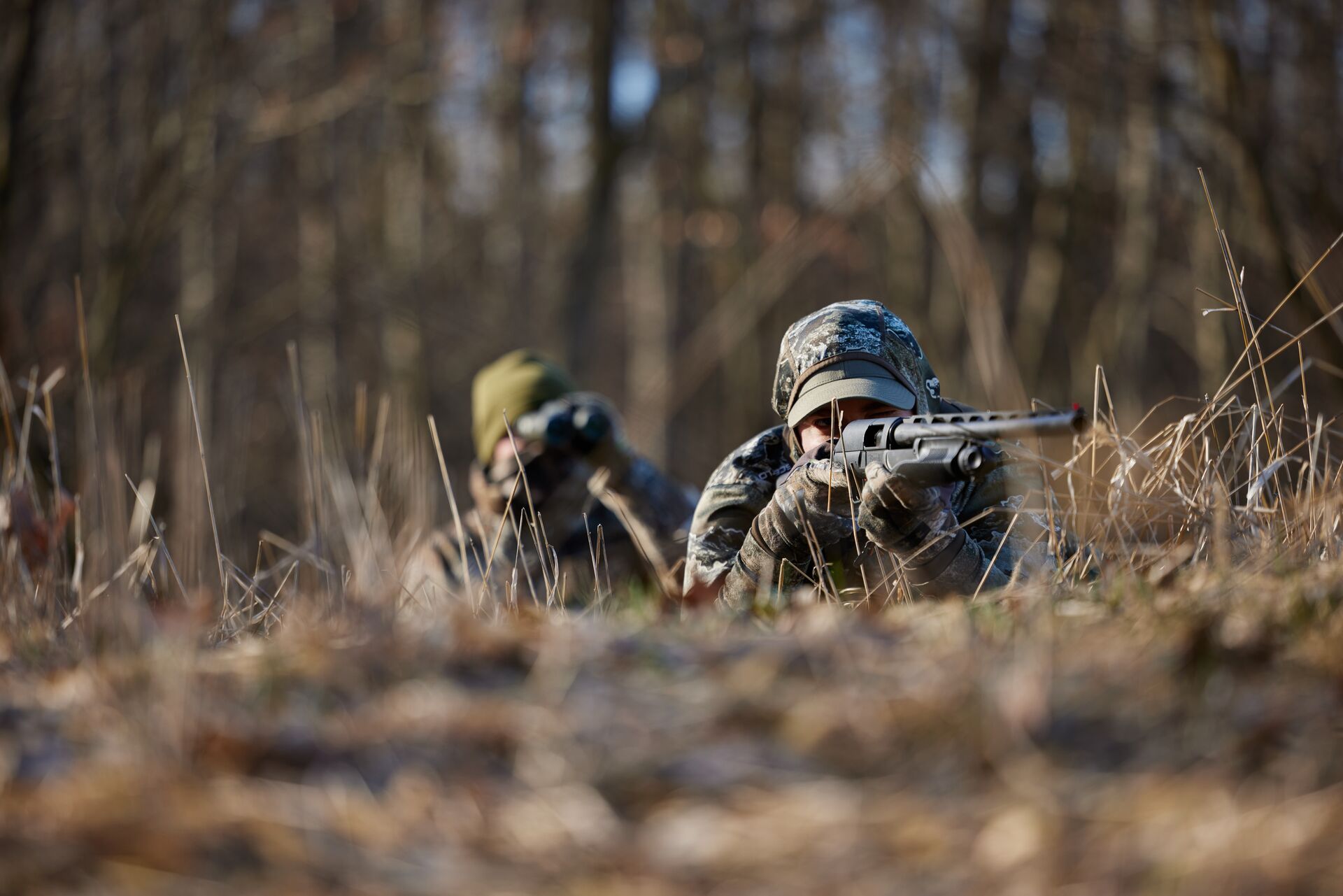 Turkey hunters waiting and aiming in the field, tips for new hunters concept. 