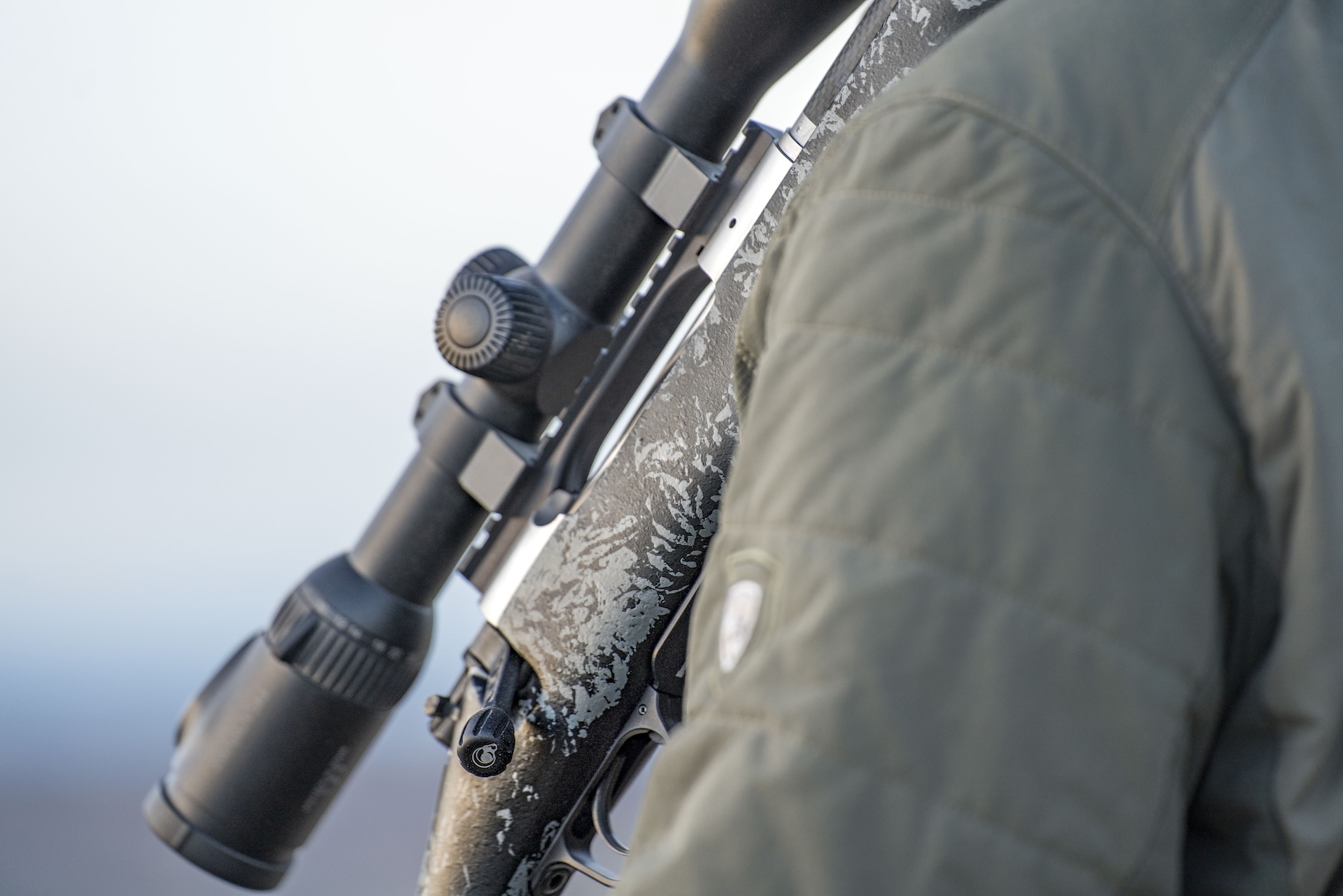 Close-up of a bolt action rifle and scope. 