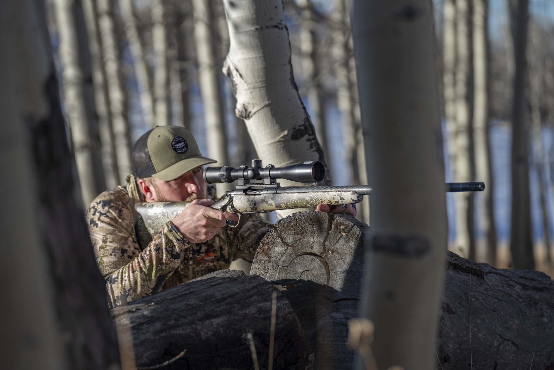 Hunter aims a rifle, what is a bolt action rifle concept. 