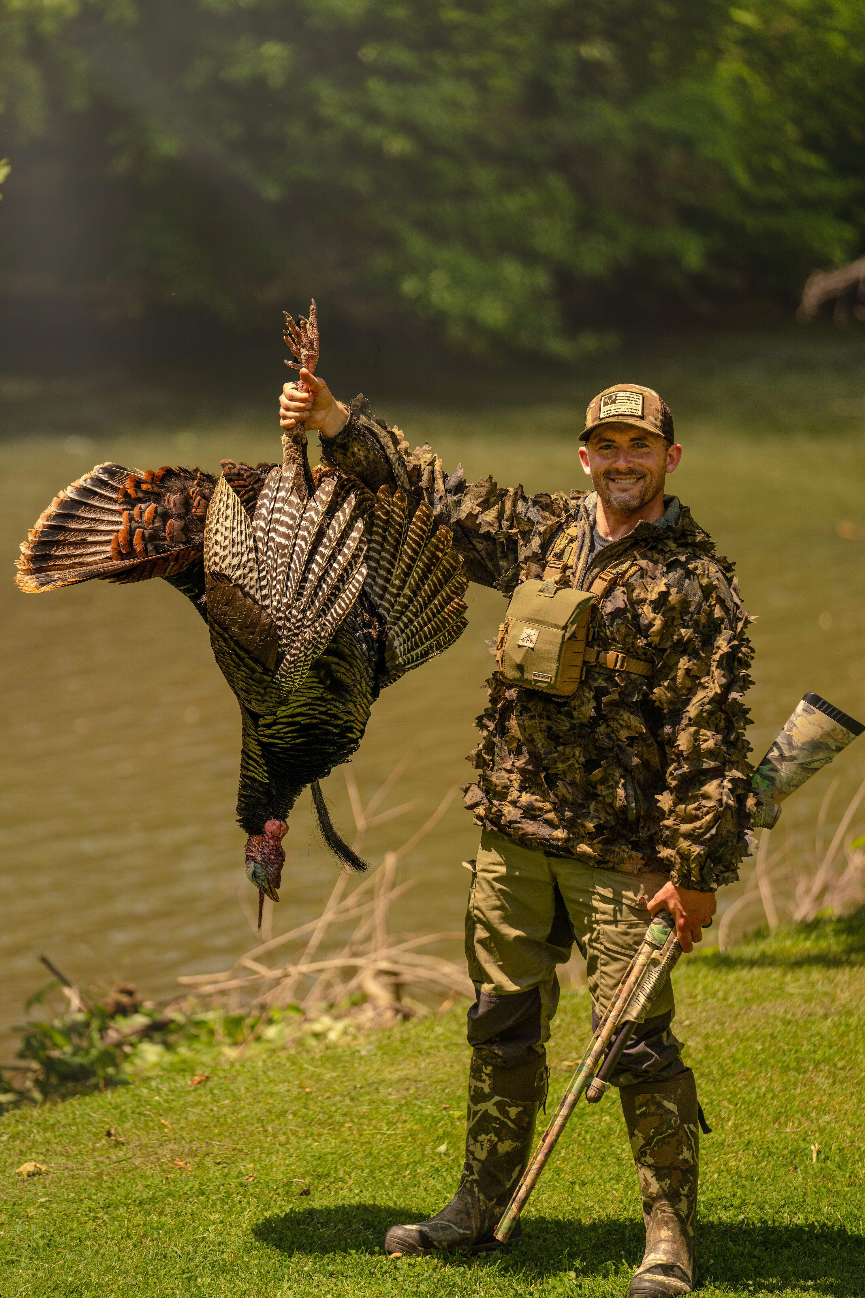 Hunter holding up a turkey after a hunt. 