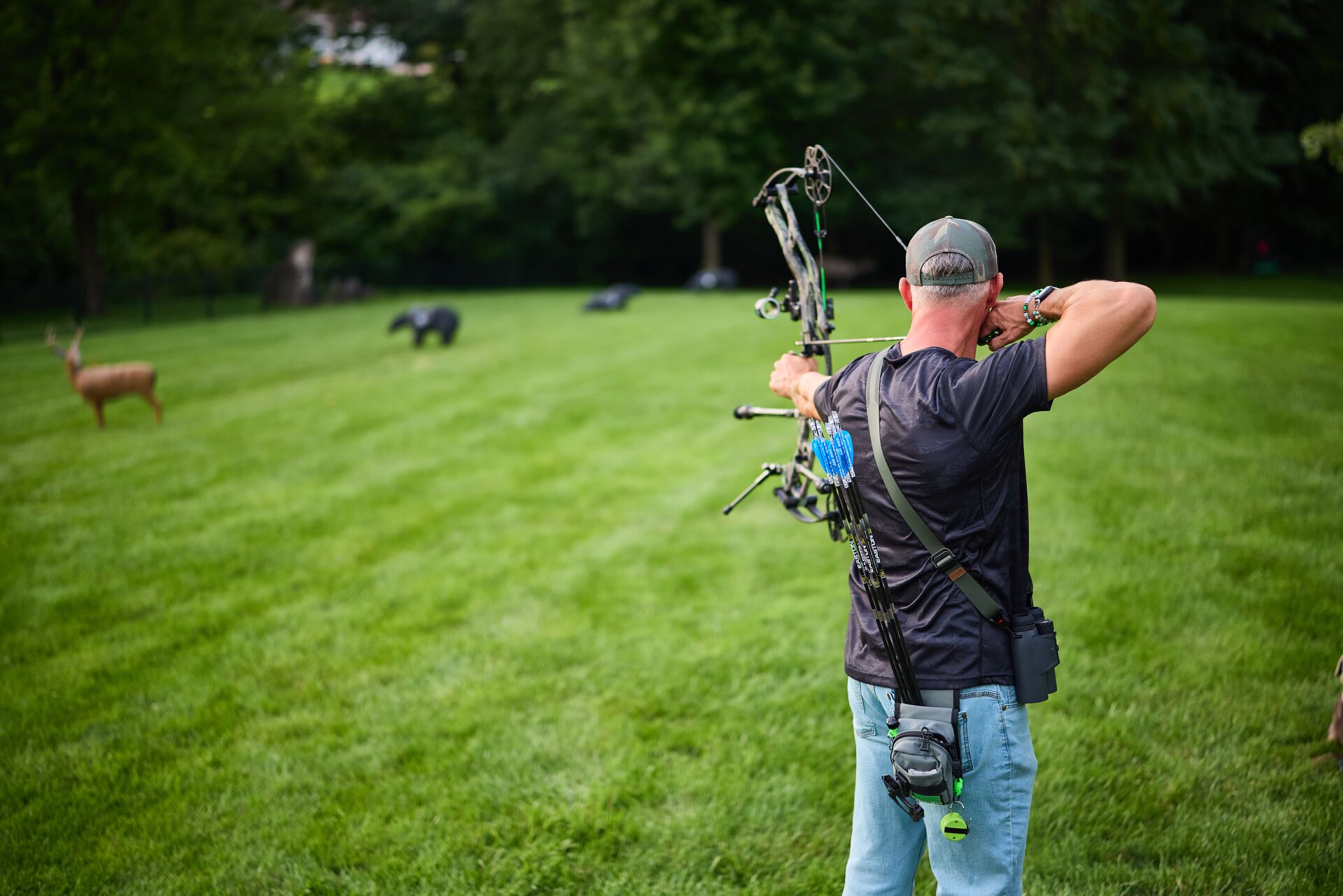 Bowhunter practicing with targets, how to shoot a bow and arrow concept.