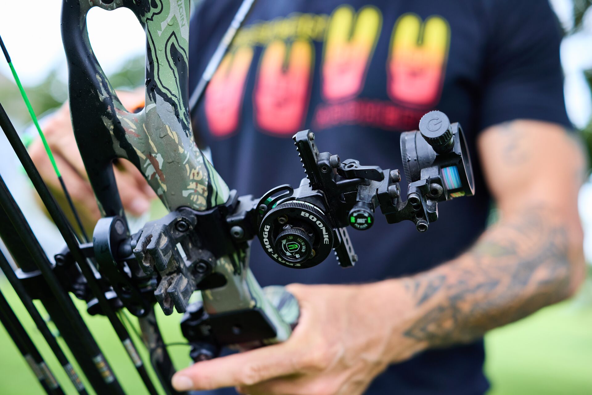Close-up of compound bow sight and accessories.