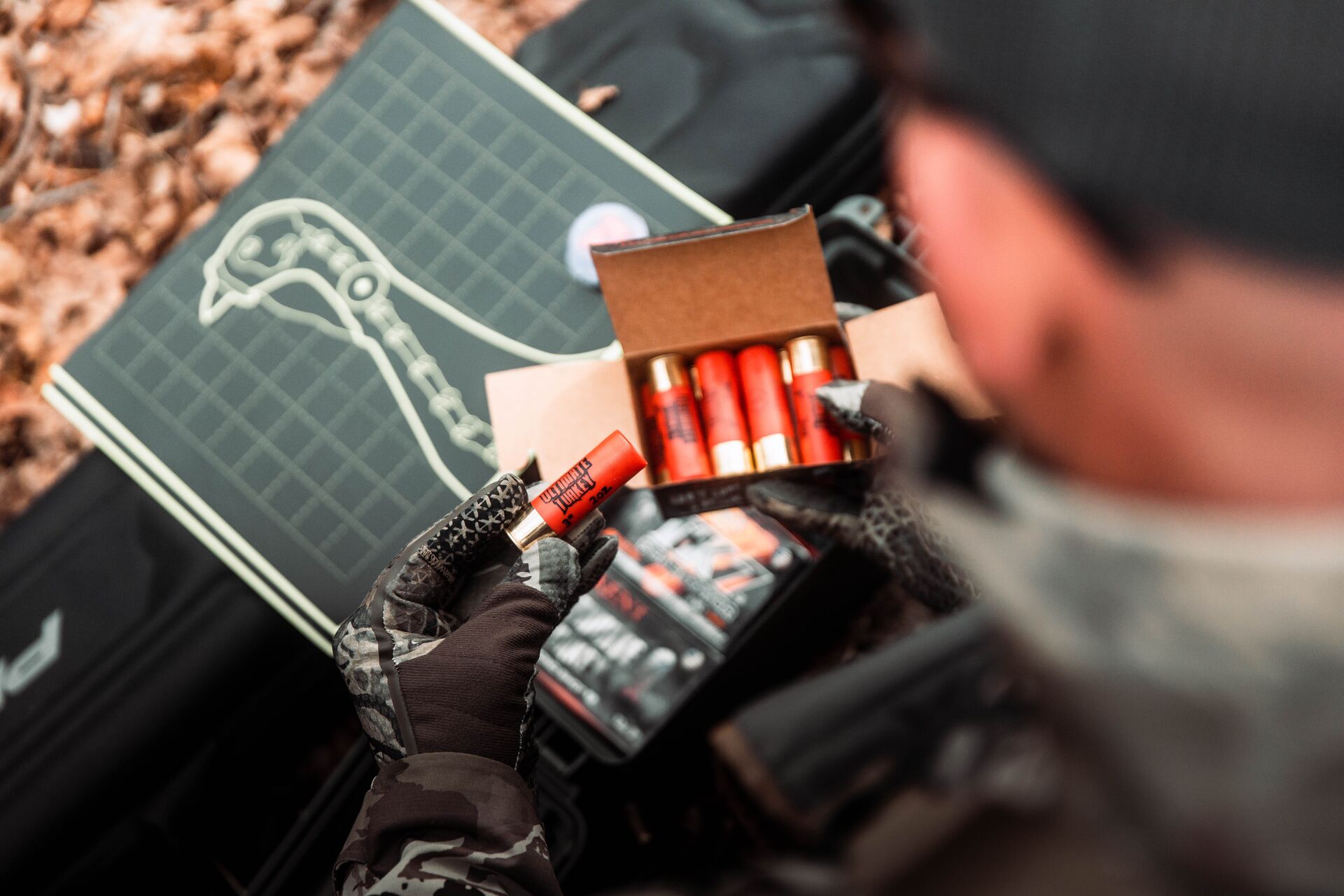 Hunter looks at shotgun shells for turkey hunt, different types of ammunition concept. 