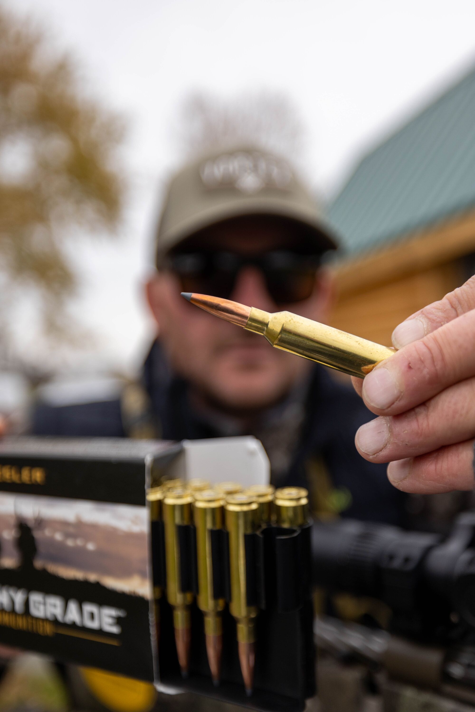 Close-up of hunter showing rifle ammunition, types of ammunition concept. 