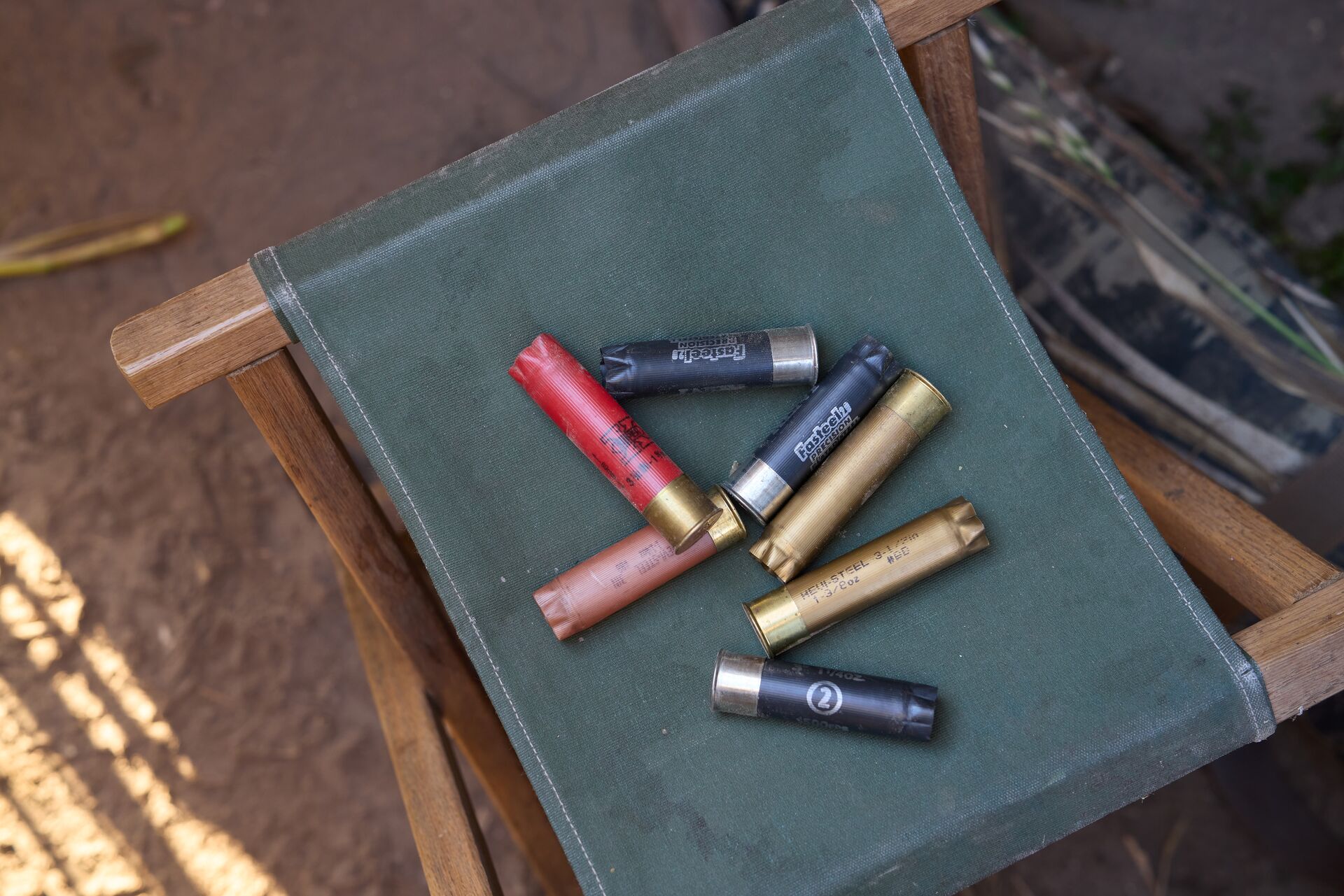 Various shotgun shells on a chair, what type of ammunition is used in a shotgun​ concept. 