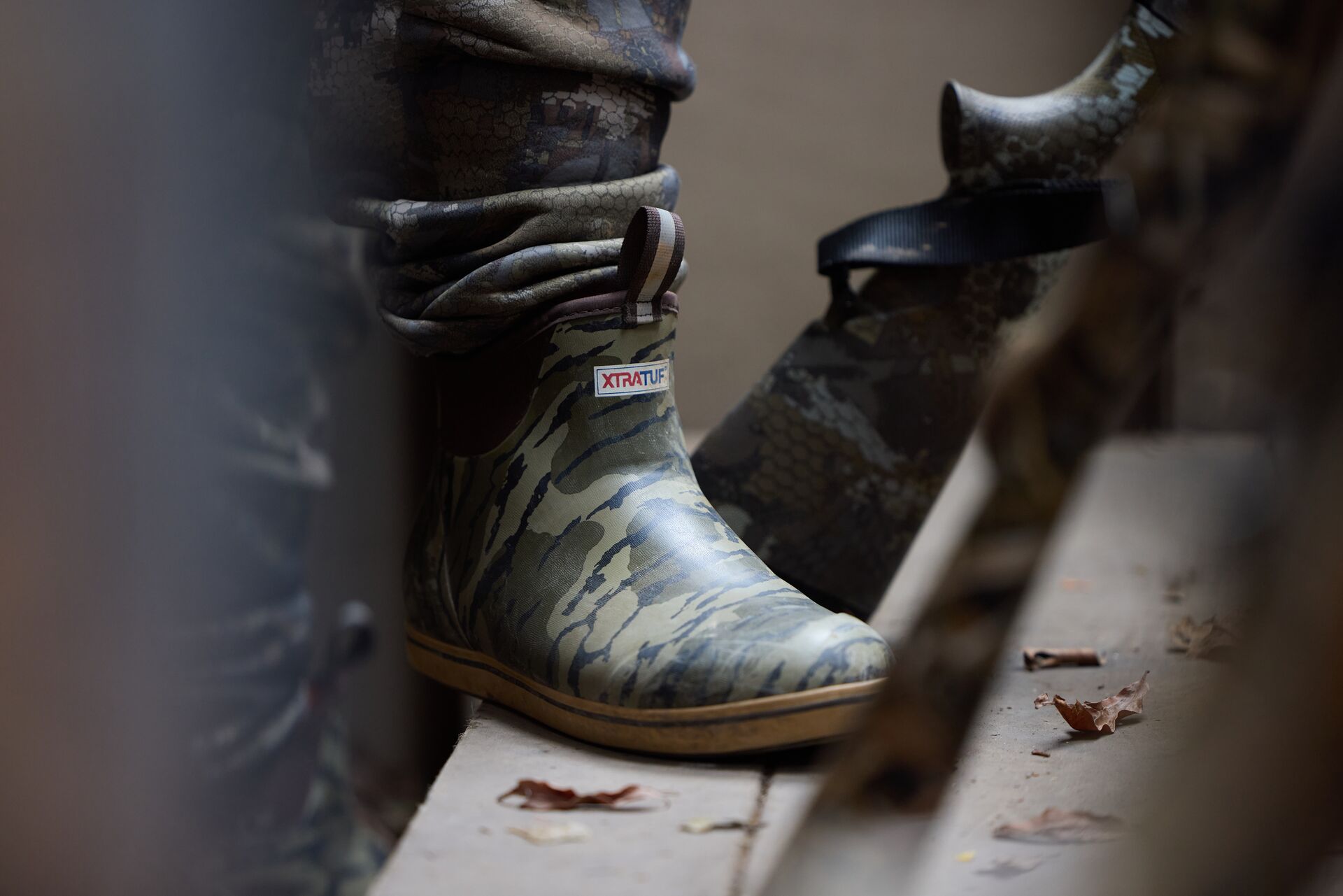 Close-up of hunting boot and shotgun for waterfowl hunt.