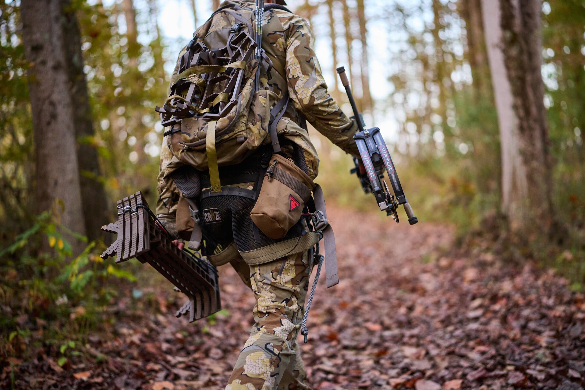 Hunter carrying gear in the woods, hunting equipment concept.