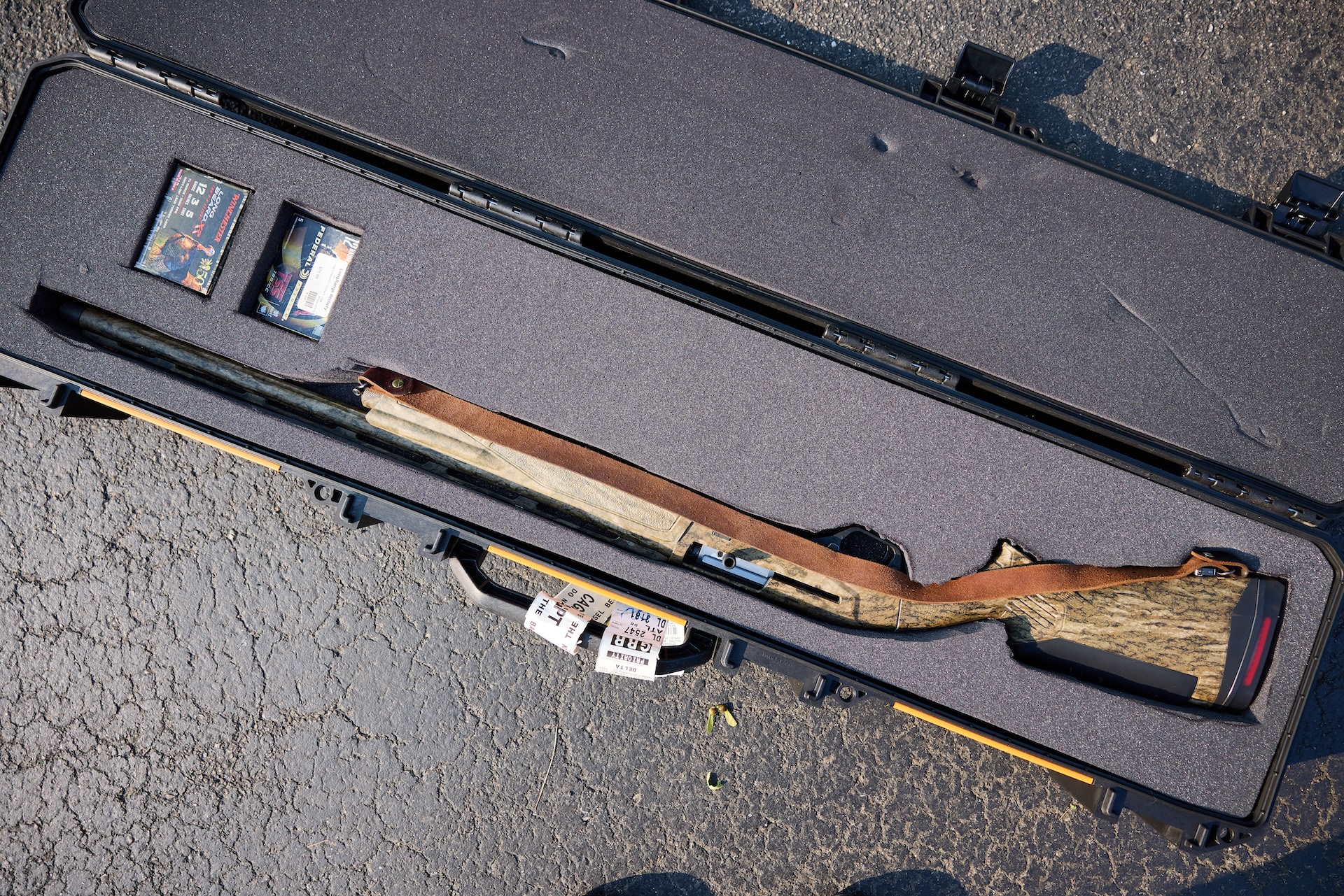 Hunting rifle and ammo in open hard case for transport, hunting safety list concept. 